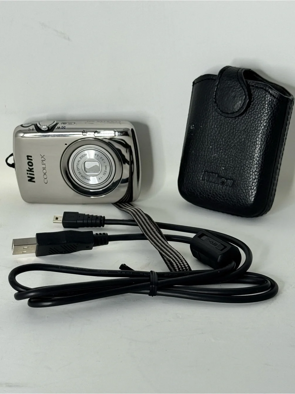 Nikon COOLPIX Silver Point-and-Shoot Camera with Black Case with charger cable
